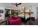 Spacious main bedroom features a four-poster bed, sofa, and sliding glass doors to the outdoor space at 6417 N 52Nd Pl, Paradise Valley, AZ 85253