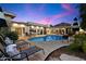 This backyard features a swimming pool, wood decking, lounge chairs, and desert landscaping at 6417 N 52Nd Pl, Paradise Valley, AZ 85253
