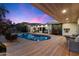 Enjoy this beautiful backyard swimming pool and the surrounding deck and desert landscape, perfect for relaxation at 6417 N 52Nd Pl, Paradise Valley, AZ 85253