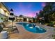 Relax by the pool surrounded by a wood deck, lounge chairs and a view of the pink and blue sunset at 6417 N 52Nd Pl, Paradise Valley, AZ 85253