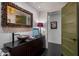 Modern powder room featuring a vessel sink, custom lighting, and a decorative mirror at 6417 N 52Nd Pl, Paradise Valley, AZ 85253