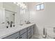 Bathroom features a double sink vanity, a large mirror, and modern faucets at 6422 W Brookhart Way, Phoenix, AZ 85083