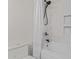 Bathroom with a tub, shower, tiled walls and black fixtures at 6422 W Brookhart Way, Phoenix, AZ 85083