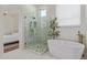 Modern bathroom featuring a glass enclosed shower, soaking tub, and gold accents at 6422 W Brookhart Way, Phoenix, AZ 85083