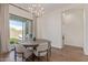 Cozy dining area featuring modern lighting and a view of the landscaped backyard at 6422 W Brookhart Way, Phoenix, AZ 85083