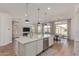 Expansive open-concept kitchen with a large island, stainless steel appliances, and adjacent living and dining areas at 6422 W Brookhart Way, Phoenix, AZ 85083
