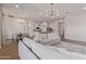 Open-concept living space with modern lighting, plush seating, and hardwood flooring at 6422 W Brookhart Way, Phoenix, AZ 85083