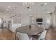 Open-concept living space featuring a dining table and kitchen island at 6422 W Brookhart Way, Phoenix, AZ 85083