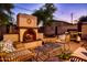 Outdoor patio featuring a fireplace, comfortable seating, and a gas grill, perfect for outdoor gatherings at 6901 E Portland St, Scottsdale, AZ 85257