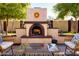 Relaxing backyard with a stucco fireplace, comfortable seating, and well-manicured landscaping at 6901 E Portland St, Scottsdale, AZ 85257