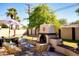 Inviting backyard patio with a stucco fireplace, comfortable seating, and a stylish umbrella at 6901 E Portland St, Scottsdale, AZ 85257