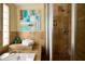 Elegant bathroom with a tiled shower and separate soaking tub, complemented by stylish decor and natural light at 6901 E Portland St, Scottsdale, AZ 85257