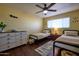 Inviting bedroom with twin beds, stylish decor, hardwood floors, and a ceiling fan, creating a cozy space at 6901 E Portland St, Scottsdale, AZ 85257