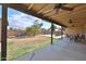 Spacious backyard featuring a covered patio, mature tree, and block fence offering privacy at 7125 W Canterbury Dr, Peoria, AZ 85345