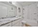 Bright bathroom features a marble countertop, ample cabinet space, and a modern bathtub with shower at 7125 W Canterbury Dr, Peoria, AZ 85345