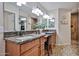 Stylish bathroom with dual vanities, granite countertops, modern lighting, and a separate shower, creating a spa-like retreat at 7125 W Canterbury Dr, Peoria, AZ 85345