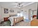 Cozy bedroom features a rustic wooden bed, ceiling fan, and warm decor at 7125 W Canterbury Dr, Peoria, AZ 85345