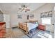 Bedroom features a rustic wooden bed, ceiling fan, warm decor, and nice view from the window at 7125 W Canterbury Dr, Peoria, AZ 85345