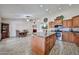 Open kitchen showcasing an island, stainless steel appliances, and seamless flow into the adjacent dining area at 7125 W Canterbury Dr, Peoria, AZ 85345