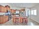 Spacious kitchen featuring a large island, granite countertops, stainless steel appliances, and custom wood cabinetry at 7125 W Canterbury Dr, Peoria, AZ 85345