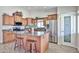 Spacious kitchen featuring an island, stainless steel appliances, granite countertops, and custom wood cabinetry at 7125 W Canterbury Dr, Peoria, AZ 85345