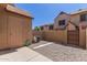 Fenced backyard with gravel, a shed, and the exterior of a beige home at 7977 W Wacker Rd # 253, Peoria, AZ 85381
