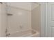 Tiled tub shower in a bathroom featuring a white interior and door at 7977 W Wacker Rd # 253, Peoria, AZ 85381