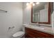 Bathroom with a single sink vanity, brushed nickel fixtures, toilet, and lighting at 7977 W Wacker Rd # 253, Peoria, AZ 85381