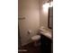 Clean half-bathroom with a toilet, dark vanity, and a mirror at 7977 W Wacker Rd # 253, Peoria, AZ 85381