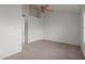 Bright bedroom features a ceiling fan, neutral carpet, and spacious closet at 7977 W Wacker Rd # 253, Peoria, AZ 85381