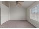 A bright bedroom with carpet, ceiling fan, and large closet at 7977 W Wacker Rd # 253, Peoria, AZ 85381