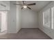 Well-lit bedroom with a ceiling fan, large windows, and neutral colored carpet at 7977 W Wacker Rd # 253, Peoria, AZ 85381