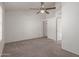 Carpeted bedroom featuring a ceiling fan, closet, and a window for ample natural light at 7977 W Wacker Rd # 253, Peoria, AZ 85381