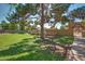 Green grass area with mature tree providing ample shade for lounging, situated near the community pool at 7977 W Wacker Rd # 253, Peoria, AZ 85381