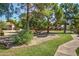 Landscaped common area featuring lush greenery, mature trees, and walking path at 7977 W Wacker Rd # 253, Peoria, AZ 85381