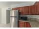 Close-up view of the kitchen cabinets and a stainless steel fridge, offering ample storage at 7977 W Wacker Rd # 253, Peoria, AZ 85381