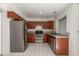 Well-lit kitchen featuring stainless steel appliances, granite counters, and wood cabinets for a functional cooking space at 7977 W Wacker Rd # 253, Peoria, AZ 85381