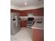 Well-lit kitchen featuring stainless steel appliances, granite countertops, and classic wooden cabinets at 7977 W Wacker Rd # 253, Peoria, AZ 85381