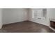 Living room with fireplace, wood-look tile flooring, a window, and a front door at 7977 W Wacker Rd # 253, Peoria, AZ 85381