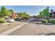 Community parking area with assigned covered parking spaces and mature landscaping at 7977 W Wacker Rd # 253, Peoria, AZ 85381