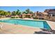 Inviting community pool surrounded by lush landscaping with a shaded pergola seating area at 7977 W Wacker Rd # 253, Peoria, AZ 85381