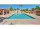 Community pool with sun loungers and covered seating areas, complemented by desert landscaping at 7977 W Wacker Rd # 253, Peoria, AZ 85381
