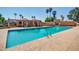 Community pool featuring refreshing water, shaded seating areas, and lush palm trees at 7977 W Wacker Rd # 253, Peoria, AZ 85381