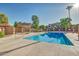 Clean community pool with lounge seating and desert foliage, set against the backdrop of residential buildings at 7977 W Wacker Rd # 253, Peoria, AZ 85381
