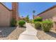 Charming walkway with lush landscaping leads to a well-maintained property and beautiful desert foliage at 7977 W Wacker Rd # 253, Peoria, AZ 85381