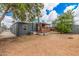 An inviting backyard offers a cozy covered patio and ample space for outdoor enjoyment at 8107 E Butte St, Mesa, AZ 85207