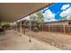 Large backyard with covered patio, gravel landscaping, and privacy fence at 8107 E Butte St, Mesa, AZ 85207