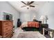 Simple bedroom with a ceiling fan, neutral walls and tiled floor at 8107 E Butte St, Mesa, AZ 85207
