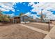 Single-story home featuring neutral toned exterior, gravel landscaping, desert foliage, and gated entrance at 8107 E Butte St, Mesa, AZ 85207