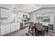 Updated kitchen featuring white cabinets, stainless steel appliances, and adjacent dining area at 8107 E Butte St, Mesa, AZ 85207